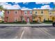 Colorful townhouses featuring landscaped grounds and dedicated parking spaces in a well-maintained community at 3021 Red Ginger Rd, Kissimmee, FL 34747