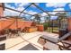 Inviting outdoor living area featuring a hot tub, seating, and lush landscaping for relaxation and entertaining at 3021 Red Ginger Rd, Kissimmee, FL 34747