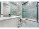 Modern bathroom with blue tile, a glass-enclosed shower, and a sleek vanity at 3037 Seigneury Dr, Windermere, FL 34786