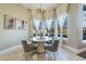 Bright dining area features a bay window, chandelier, and seating for four at 3037 Seigneury Dr, Windermere, FL 34786