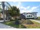 Beautiful home exterior featuring a screened-in patio, manicured lawn, and lush greenery at 3037 Seigneury Dr, Windermere, FL 34786