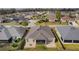 Aerial view of the backyard of the home, showing the screened-in patio and surrounding neighborhood at 3202 Condrey Ct, The Villages, FL 32163