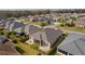 Aerial view of the backyard and surrounding community, showing the proximity of homes and neighborhood features at 3202 Condrey Ct, The Villages, FL 32163