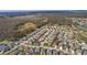 Aerial perspective of a residential area showcases a community surrounded by scenic lakes and vast woodlands at 3202 Condrey Ct, The Villages, FL 32163