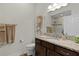 Bathroom featuring granite countertops, a decorative bird sculpture and a tiled shower at 3202 Condrey Ct, The Villages, FL 32163