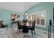 Stylish dining room with a modern chandelier, plantation shutters, and a sophisticated decor at 3202 Condrey Ct, The Villages, FL 32163