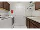 Laundry room featuring modern washer and dryer, and granite countertops at 3202 Condrey Ct, The Villages, FL 32163