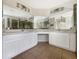 Bright bathroom featuring double sinks, white cabinetry, and modern fixtures at 3230 Buck Hill Pl, Orlando, FL 32817