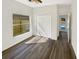 Bright bedroom with wood-look floors, a white door, and a view of the backyard at 3230 Buck Hill Pl, Orlando, FL 32817