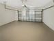 An empty garage with a sealed floor and a metal garage door at 3230 Buck Hill Pl, Orlando, FL 32817