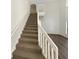 Staircase with carpeted steps and white railings leading to the second floor at 3230 Buck Hill Pl, Orlando, FL 32817