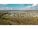 An aerial view of newly constructed single-Gathering homes, walking path, and lake in a planned community at 367 Sofia Ln, Lake Alfred, FL 33850