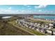 New development homes line the walking path with a serene lake view and blue skies in this aerial view at 367 Sofia Ln, Lake Alfred, FL 33850