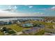 Aerial view of a community with a lake, a pool and playground near matching homes on a manicured landscape at 367 Sofia Ln, Lake Alfred, FL 33850