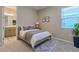 Comfortable bedroom with neutral tones, a serene ambiance, and a convenient en-suite bathroom at 367 Sofia Ln, Lake Alfred, FL 33850