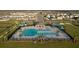 Aerial shot of a community pool, complete with lounge chairs, cabana, and lush landscaping at 367 Sofia Ln, Lake Alfred, FL 33850