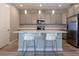 Bright kitchen with a quartz countertop island, pendant lighting, and stainless steel appliances at 367 Sofia Ln, Lake Alfred, FL 33850