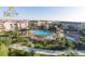 Aerial view of the community pool with lounge chairs, surrounded by lush landscaping and multi-story buildings at 4000 Breakview Dr # C207, Orlando, FL 32819