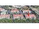 Aerial view of condo complex with terra cotta roofs and lush greenery at 4000 Breakview Dr # C207, Orlando, FL 32819