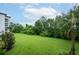 Lush green backyard with mature trees and blue sky views at 4000 Breakview Dr # C207, Orlando, FL 32819