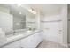 Bright bathroom featuring a double sink vanity with granite counters, and a glass-enclosed shower at 4000 Breakview Dr # C207, Orlando, FL 32819