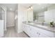 Bright bathroom featuring a double sink vanity with granite counters, and a glass-enclosed shower at 4000 Breakview Dr # C207, Orlando, FL 32819