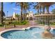 Clubhouse exterior with fountain, lush landscaping, brick pavers, and palm trees on a sunny day at 4000 Breakview Dr # C207, Orlando, FL 32819