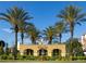 Vista Cay Resort entrance framed by palm trees and lush landscaping under a bright blue sky at 4000 Breakview Dr # C207, Orlando, FL 32819