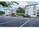 Modern condo exterior with well-maintained landscaping and parking at 4000 Breakview Dr # C207, Orlando, FL 32819