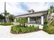 Outdoor bar with tile roof, featuring bar seating and manicured landscaping at 4000 Breakview Dr # C207, Orlando, FL 32819