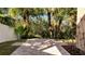 Backyard patio with view of tropical landscaping and mature trees at 4019 Alcott Cir, Orlando, FL 32828