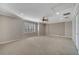 Spacious bedroom featuring neutral walls, ceiling fan and a large window with shutter-style blinds at 4019 Alcott Cir, Orlando, FL 32828