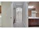 Hallway leading to the bathroom with tiled floors and archways at 4019 Alcott Cir, Orlando, FL 32828