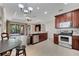 Spacious kitchen with stainless steel appliances, dark wood cabinets, and an adjacent dining area at 4019 Alcott Cir, Orlando, FL 32828