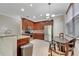 Well-lit kitchen features stainless steel appliances, granite countertops, tiled backsplash, and wooden cabinets at 4019 Alcott Cir, Orlando, FL 32828