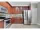 Kitchen showcases stainless steel appliances, granite countertops, and rich wood cabinetry at 4019 Alcott Cir, Orlando, FL 32828