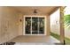 Well-maintained covered patio with ceiling fan and sliding glass doors at 4019 Alcott Cir, Orlando, FL 32828