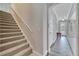 Carpeted staircase leads to the upper level, with a view of the foyer and front door at 4019 Alcott Cir, Orlando, FL 32828