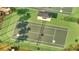 Aerial view of tennis court with net, lighting, and a covered pavilion at 4019 Alcott Cir, Orlando, FL 32828