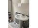 Bathroom with pedestal sink and gray tiled wall at 4864 Old Oak Tree Ct, Orlando, FL 32808