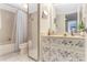 Bathroom featuring floral accents, a large mirror, vanity, and shower tub combination at 5293 Willow Ct # 522, Orlando, FL 32811