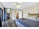 Bedroom featuring gray wood floors, a ceiling fan, and a closet with mirrored sliding doors at 5293 Willow Ct # 522, Orlando, FL 32811