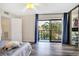 Bright bedroom with sliding doors to a balcony and a large mirrored closet at 5293 Willow Ct # 522, Orlando, FL 32811