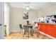 Dining area with colorful kitchen featuring stainless steel appliances and modern bar stools at 5293 Willow Ct # 522, Orlando, FL 32811