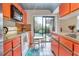 Bright kitchen featuring orange cabinetry, butcher block countertops and backyard access at 5293 Willow Ct # 522, Orlando, FL 32811