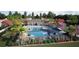 Community pool and amenity center features covered lounge area, lush landscaping, and ample seating at 5960 Vision Rd, St Cloud, FL 34771