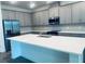 Modern kitchen with stainless steel appliances, an island with a sink, and grey cabinetry at 5960 Vision Rd, St Cloud, FL 34771