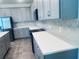 Well-appointed kitchen featuring stainless steel appliances and stylish backsplash with grey cabinetry at 5960 Vision Rd, St Cloud, FL 34771