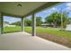 Relaxing covered patio overlooking lush landscaping at 5960 Vision Rd, St Cloud, FL 34771