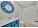 Bathroom featuring a vanity with blue cabinets and a shower-tub combination at 610 Nadina Pl, Celebration, FL 34747